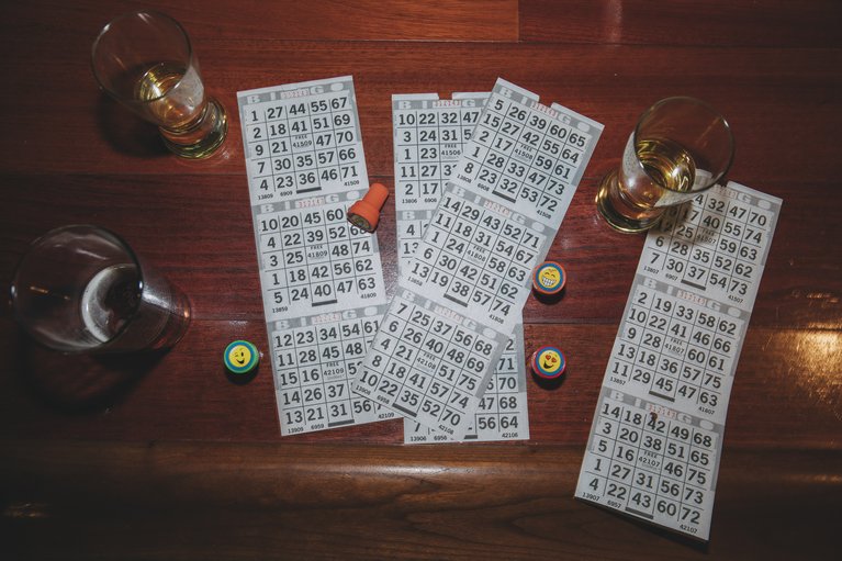 Bingo cards and drinks on the bar.
