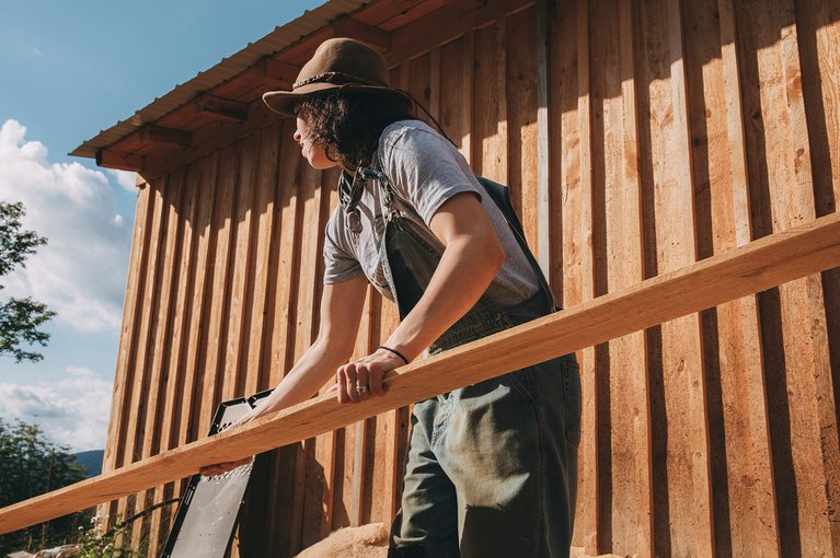 A Burton Employee Living off the Grid in Vermont | Taylor outside their sawmill.