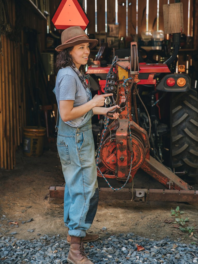 Taylor Mayo standing in front of her tractor