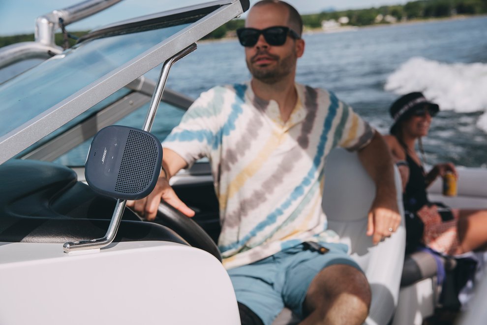 Chris driving boat with bose speaker
