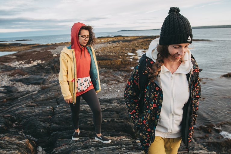 Kimmy Fasani and a friend walking along the beach.