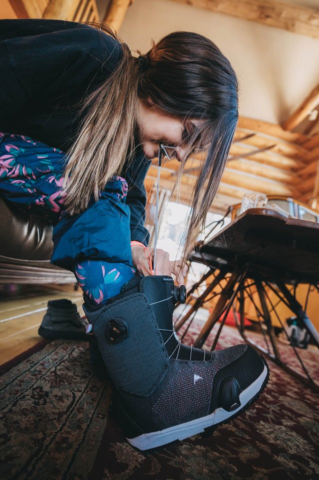 Kiana Clay putting on Snowboard Boots