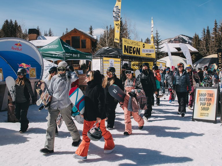 A group of women walking through the Sponsor Village at the Burton U·S·Open