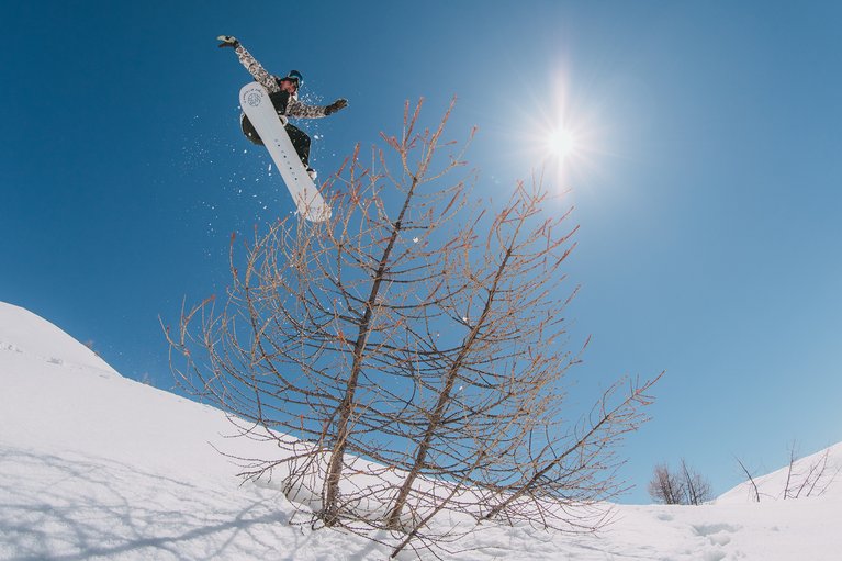 Mark McMorris airing over a tree on the Flight Attendant