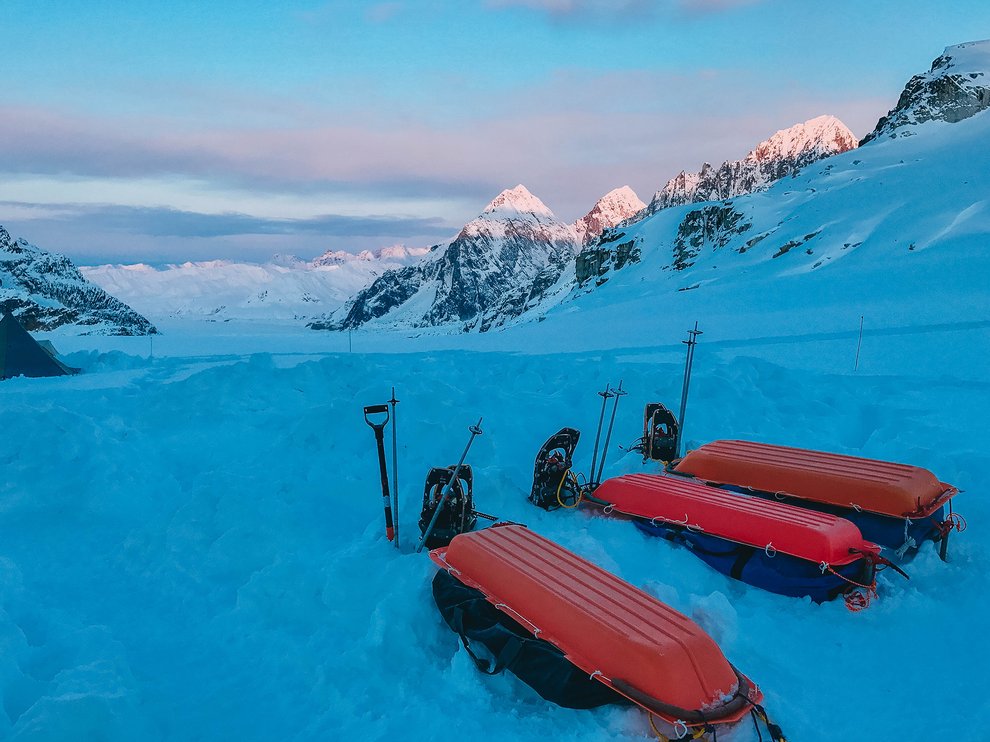 Sleds in front of mountains